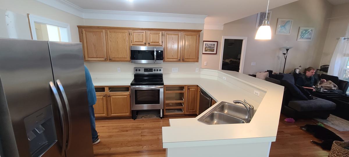 Kitchen before: oak cabinets and white laminate counters
